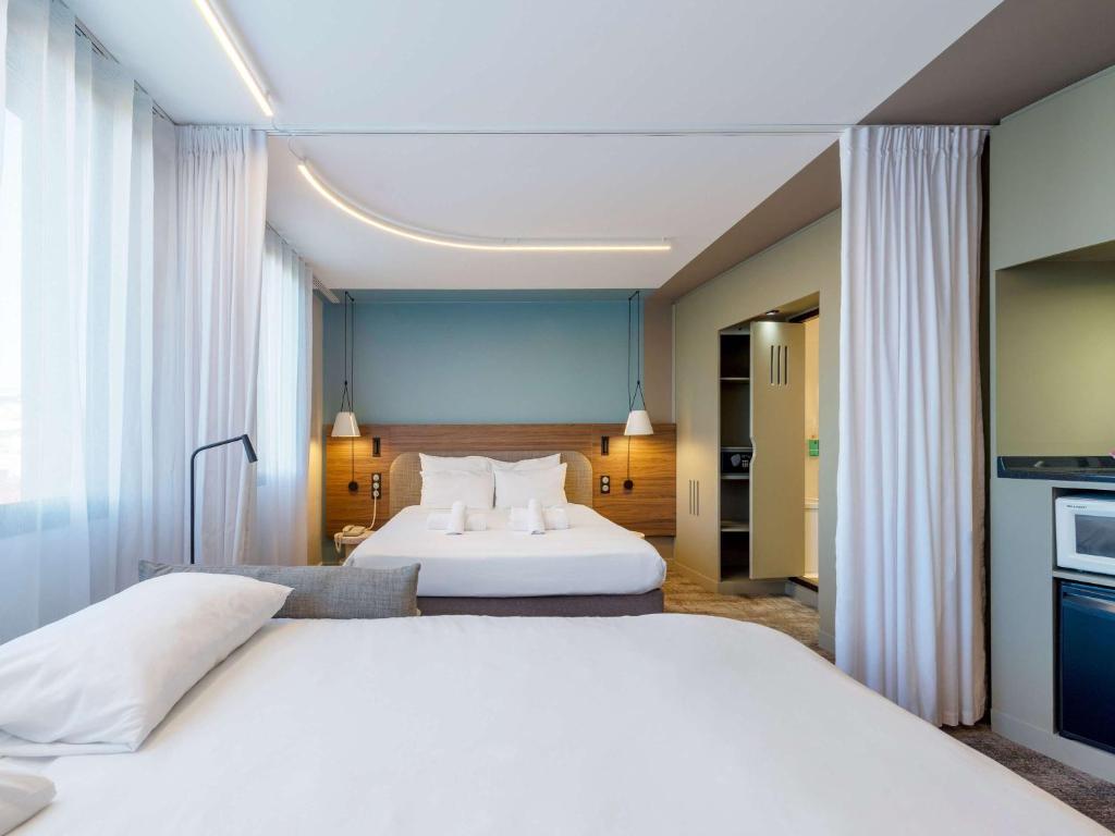 Postel nebo postele na pokoji v ubytování Novotel Suites Nancy Centre