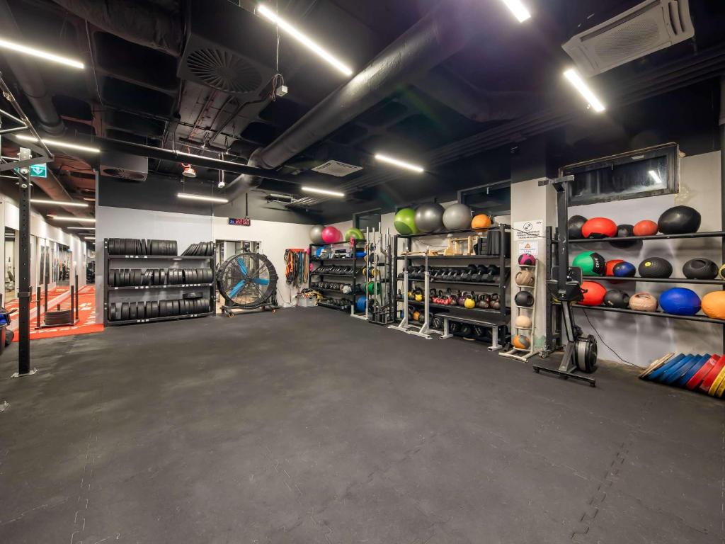 a large room with a gym with a bunch of balls at Novotel Gdańsk Marina in Gdańsk