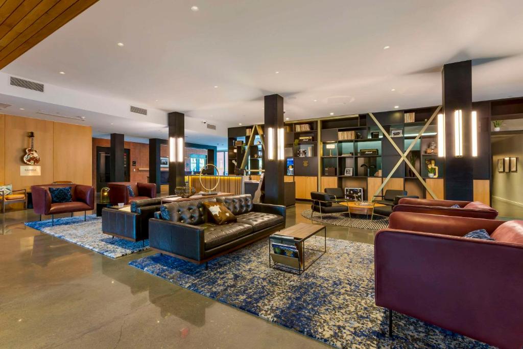 a large living room with couches and chairs at Cambria Hotel Austin Airport in Austin