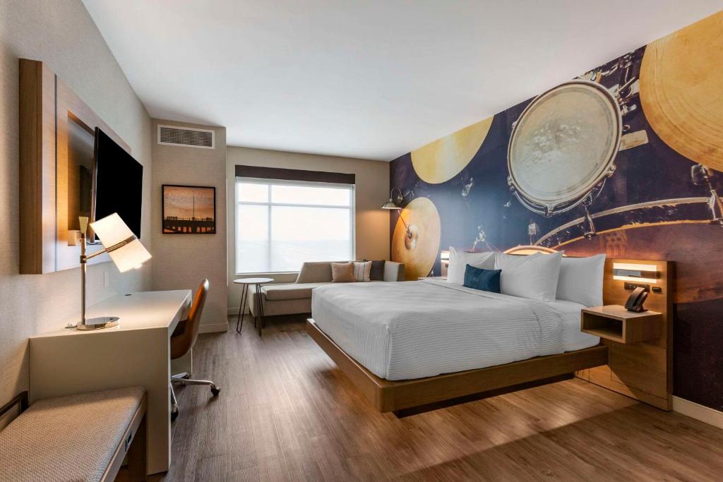 a hotel room with a bed and a couch at Cambria Hotel Austin Airport in Austin