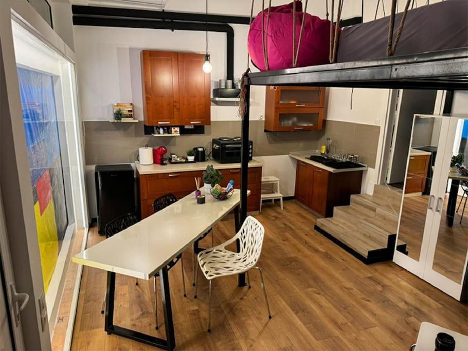 a kitchen and dining room with a loft bed at Joanna 2 Apartment in Larisa