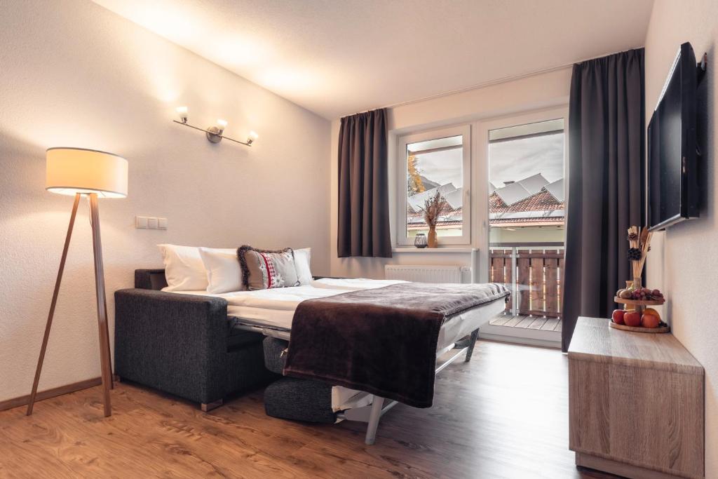 Televízia a/alebo spoločenská miestnosť v ubytovaní Alpen-Appartements Zürcher