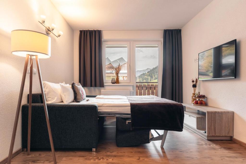 Televízia a/alebo spoločenská miestnosť v ubytovaní Alpen-Appartements Zürcher