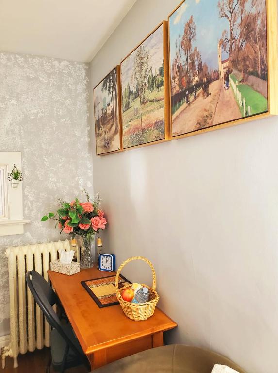 a dining room table with a basket of fruit on it at Merj's Guest House in Wolesly in Winnipeg