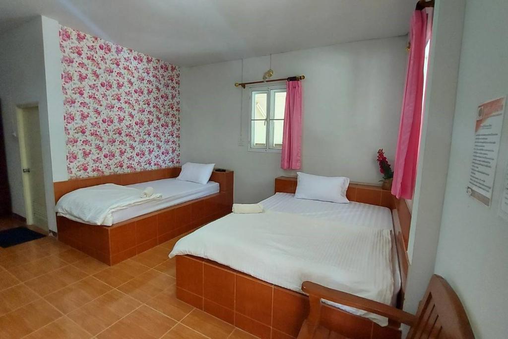 Postel nebo postele na pokoji v ubytování Rung Rueng Resort