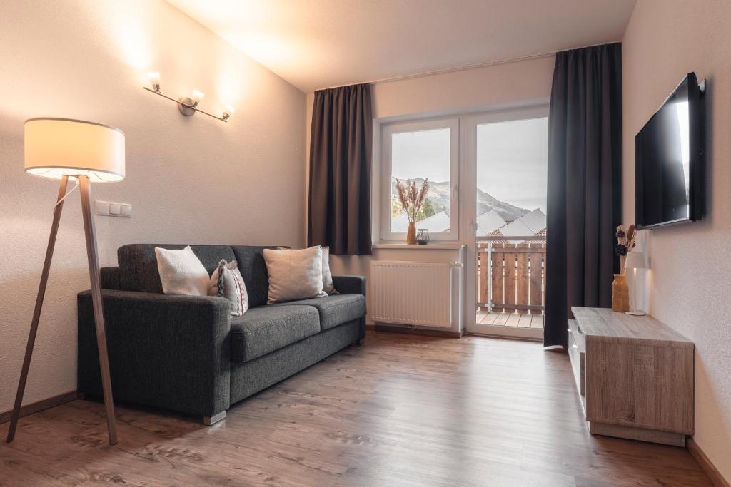 Televízia a/alebo spoločenská miestnosť v ubytovaní Alpen-Appartements Zürcher