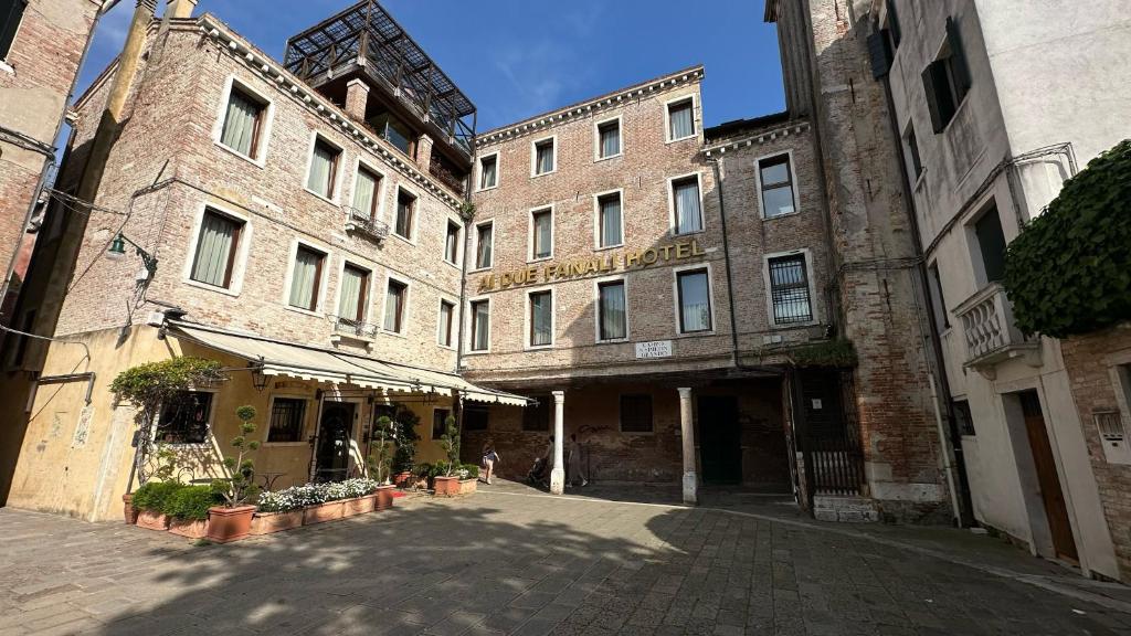 an empty street in front of a large brick building at Ai Due Fanali Adults Only in Venice