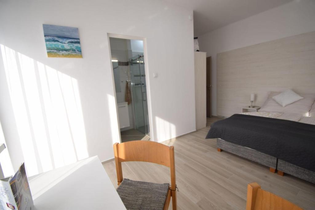 Postel nebo postele na pokoji v ubytování Omni Residence Vendégház