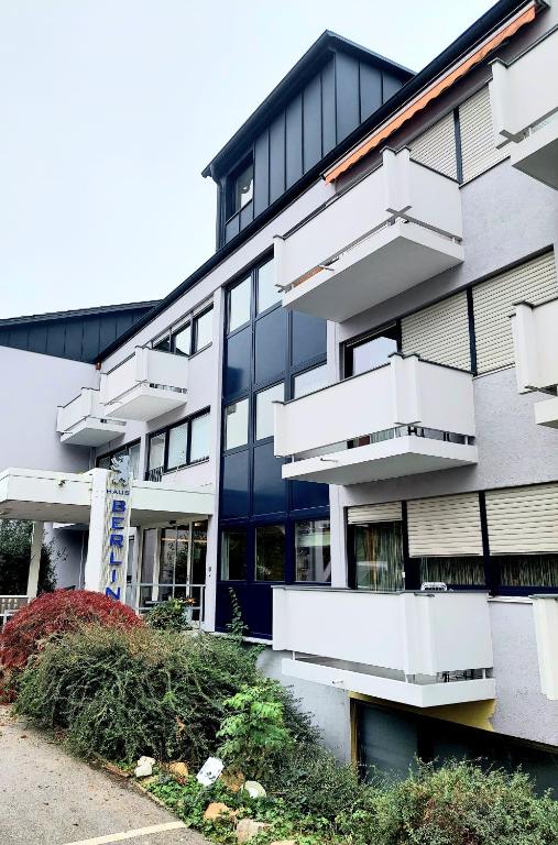 a building with white balconies on the side of it at Appartementhaus Berlin in Bad Füssing
