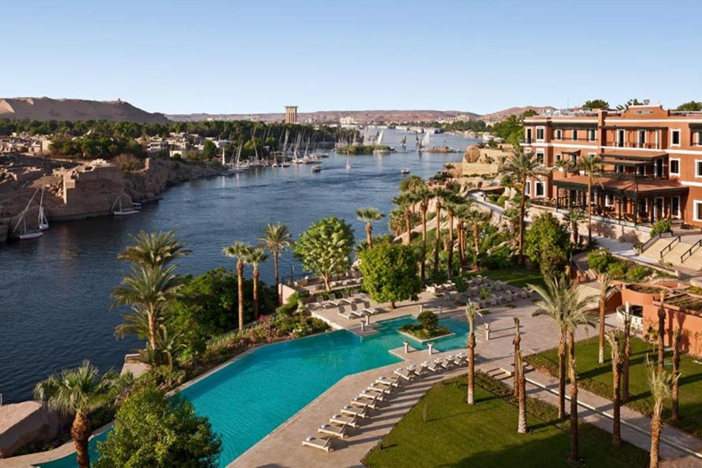 
a large body of water with palm trees at Sofitel Legend Old Cataract in Aswan

