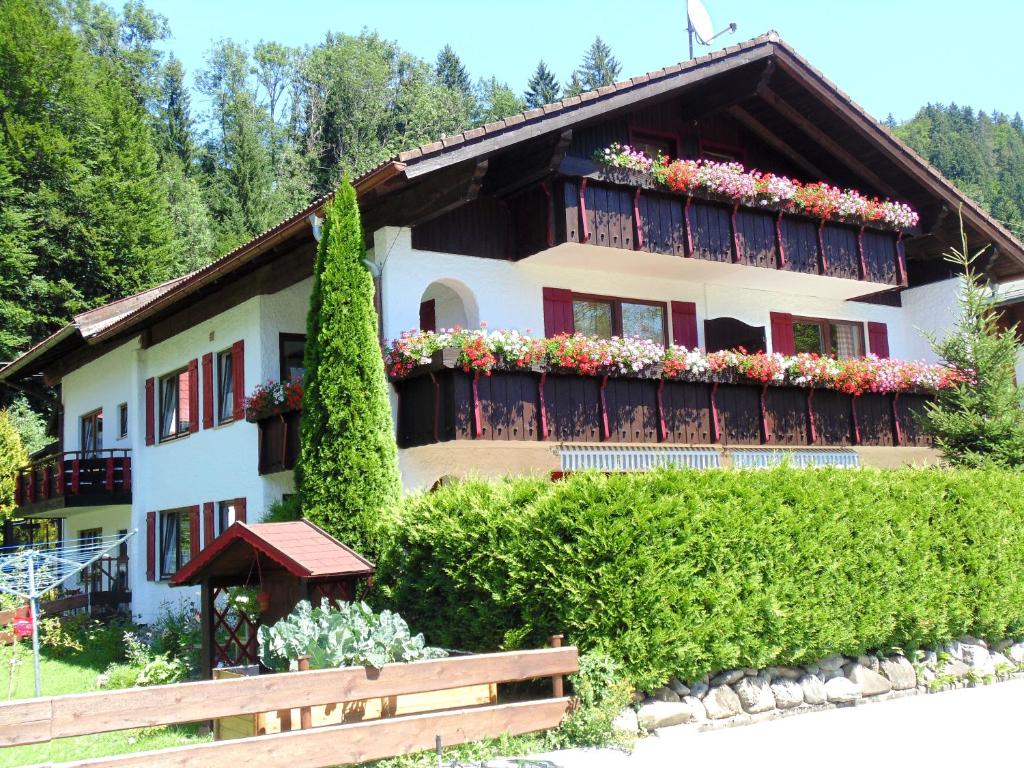 a house with flowers on the balconies of it at Thannheimer Häusl in Oberstdorf