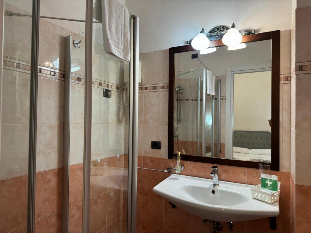 a bathroom with a sink and a mirror at EURO HOUSE INN airport in Fiumicino