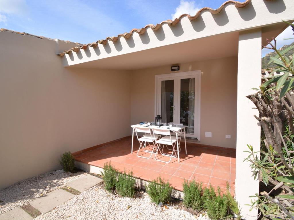 un patio con tavolo e sedie in una casa di Holiday Home Mirto Marino-9 by Interhome a Costa Rei