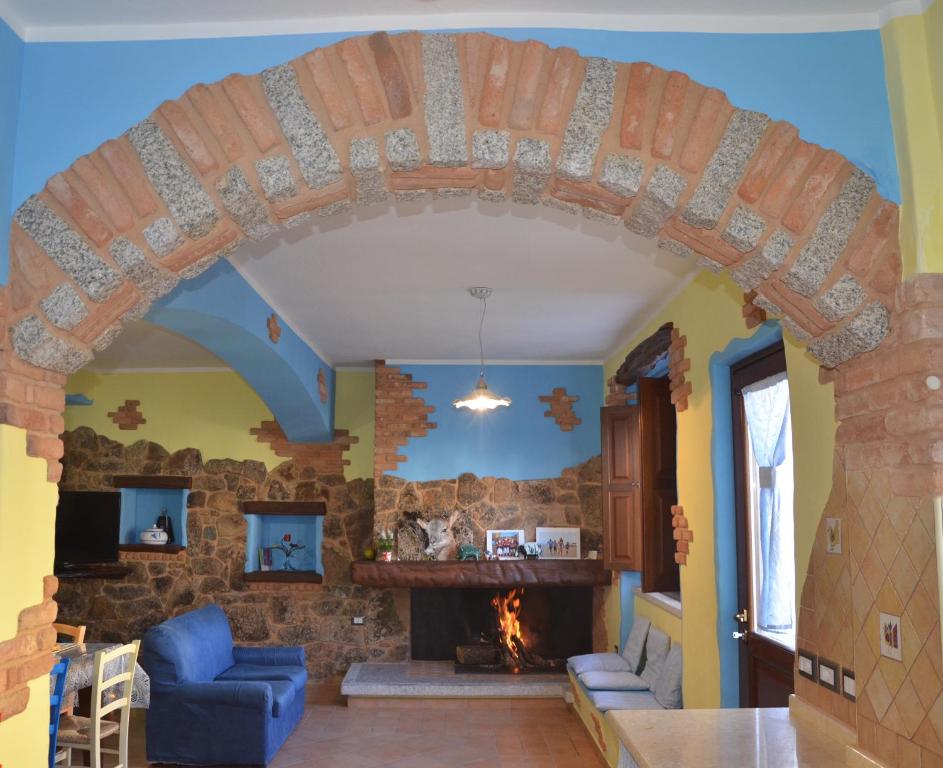 un arco en una sala de estar con chimenea de piedra en B&B La Dolce Sosta, en Fonni