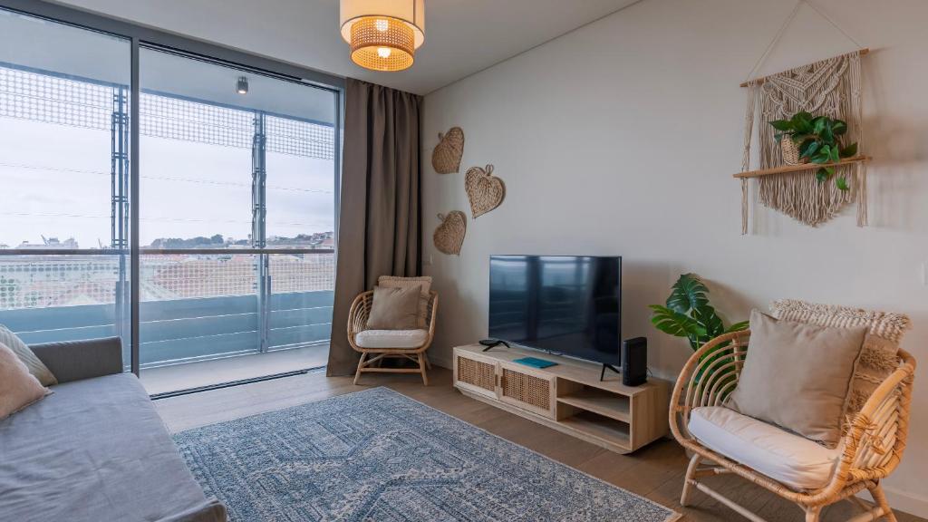 Hotel River View 1BDR Apartment by LovelyStay, a living room with a couch and a television at River View 1BDR Apartment by LovelyStay in Lisbon