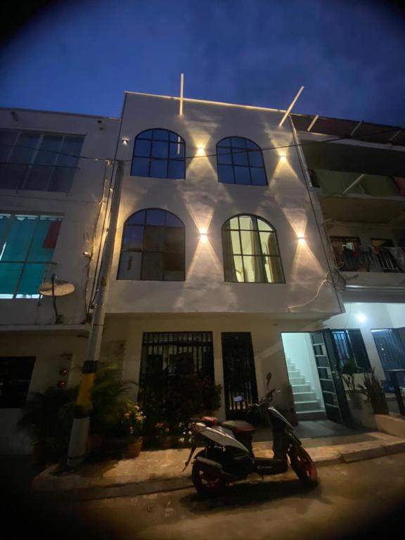 a scooter parked in front of a building with lights at Habitaciones en Doradal 203 in Doradal