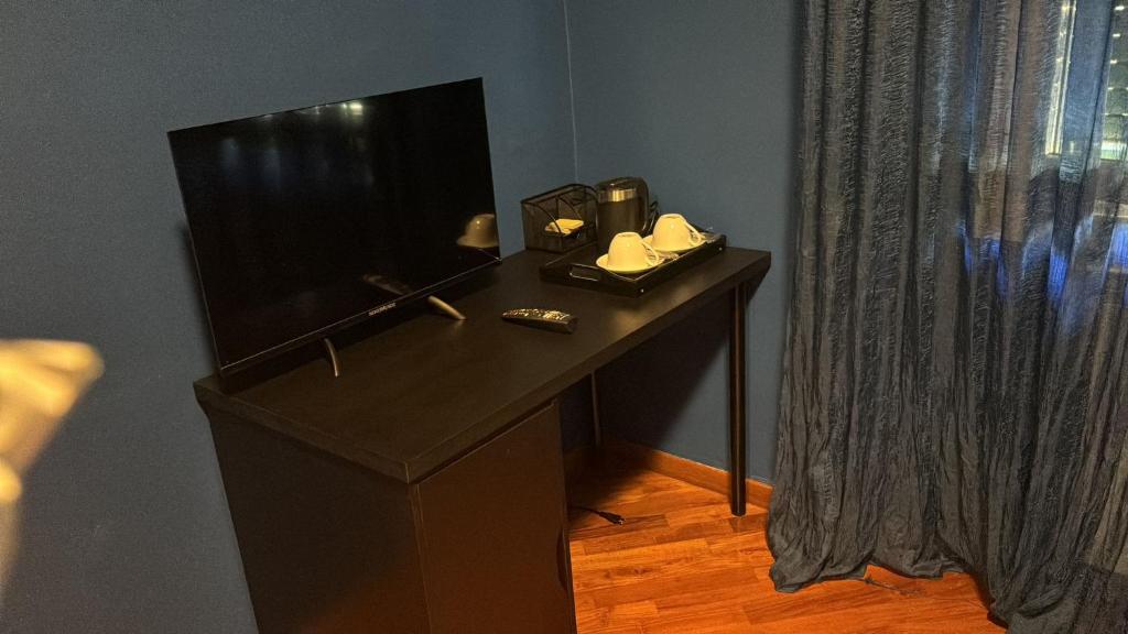 TV a/nebo společenská místnost v ubytování Milano Sud