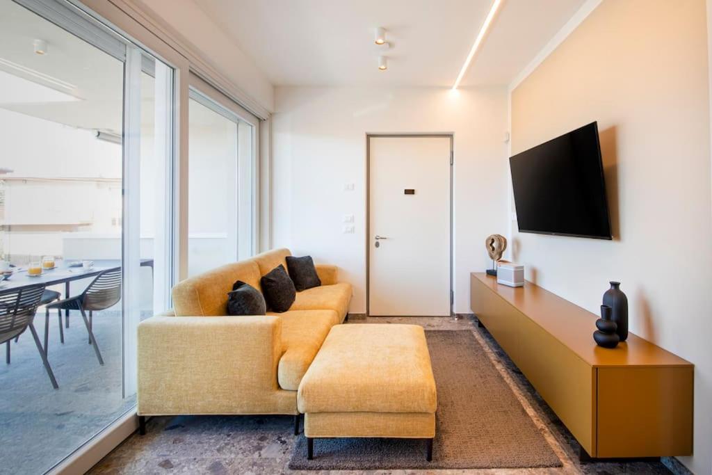 a living room with a couch and a tv at Luxury House - Small Heated Pool in Bardolino