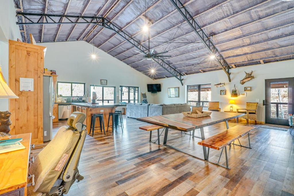 a kitchen and living room with a table and chairs at Games and Fire Pit Waterfront Beaver Lake Home! in Garfield