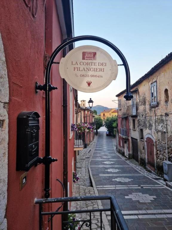 an alley with a sign on the side of a building at la corte dei filangieri rooms in Candida