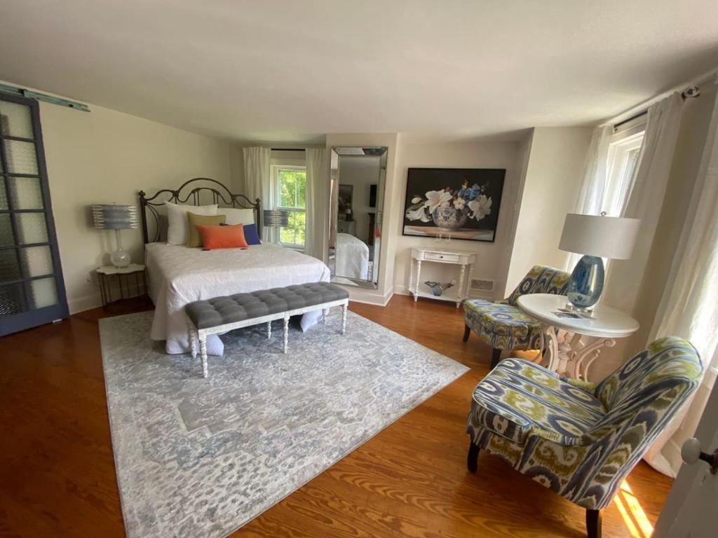a bedroom with a bed and a table and chairs at Trouvaille House Sweet Suite in Harpers Ferry