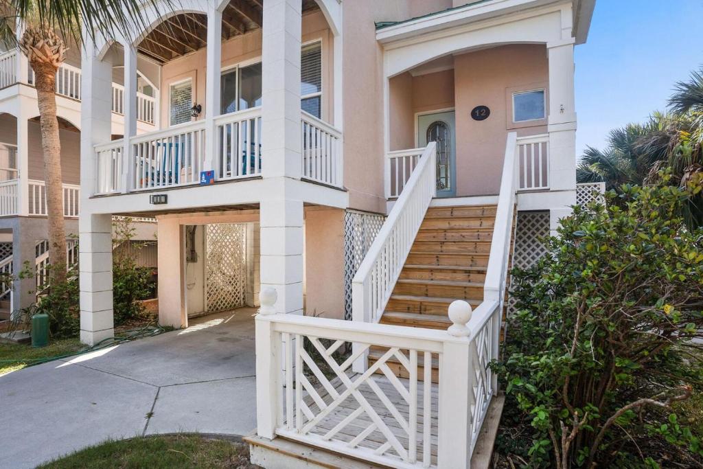 a house with a white staircase in front of it at 12 Sea Mist in Fripp Island