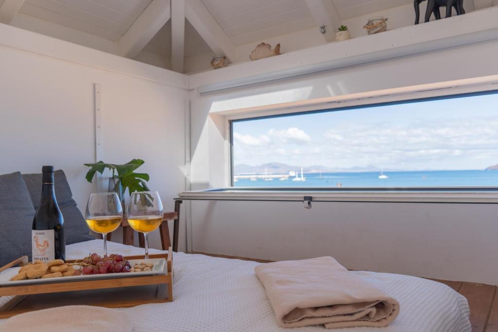 a room with a table with two glasses of wine at Villa Stars Seaview Corralejo in Corralejo