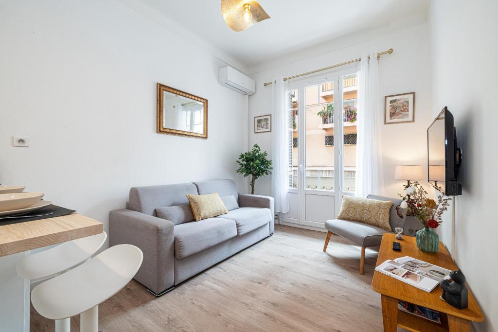 un salon avec un canapé et une table dans l'établissement 10 AMIRAL 101 - Joli 3P climatise - Centre-ville, à Nice