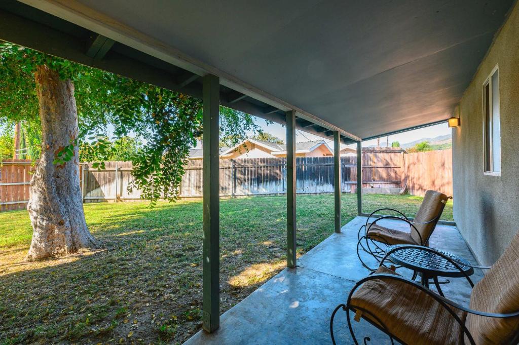 a screened porch with benches and a tree at Charming Escape with Stylish Decor & Outdoor Space in Glendora