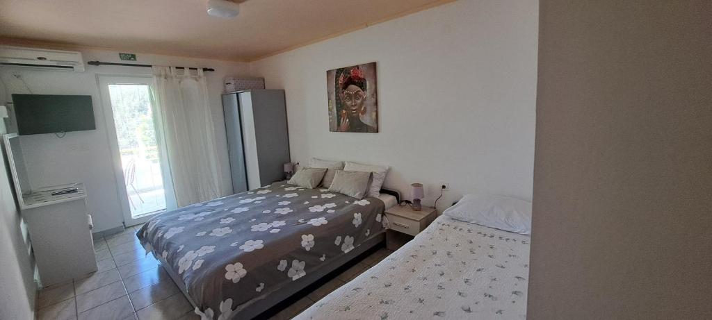 Postel nebo postele na pokoji v ubytování apartmani Natali