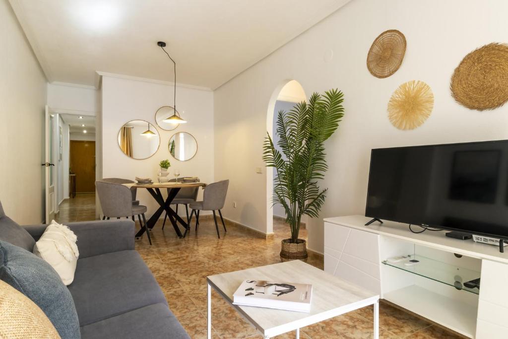 Televízia a/alebo spoločenská miestnosť v ubytovaní Apartamento Pink Medsea