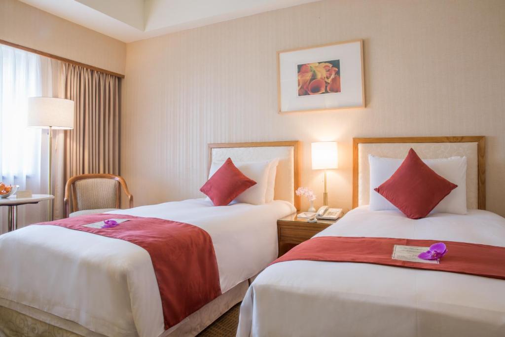 Postel nebo postele na pokoji v ubytování Hotel Riverview Taipei