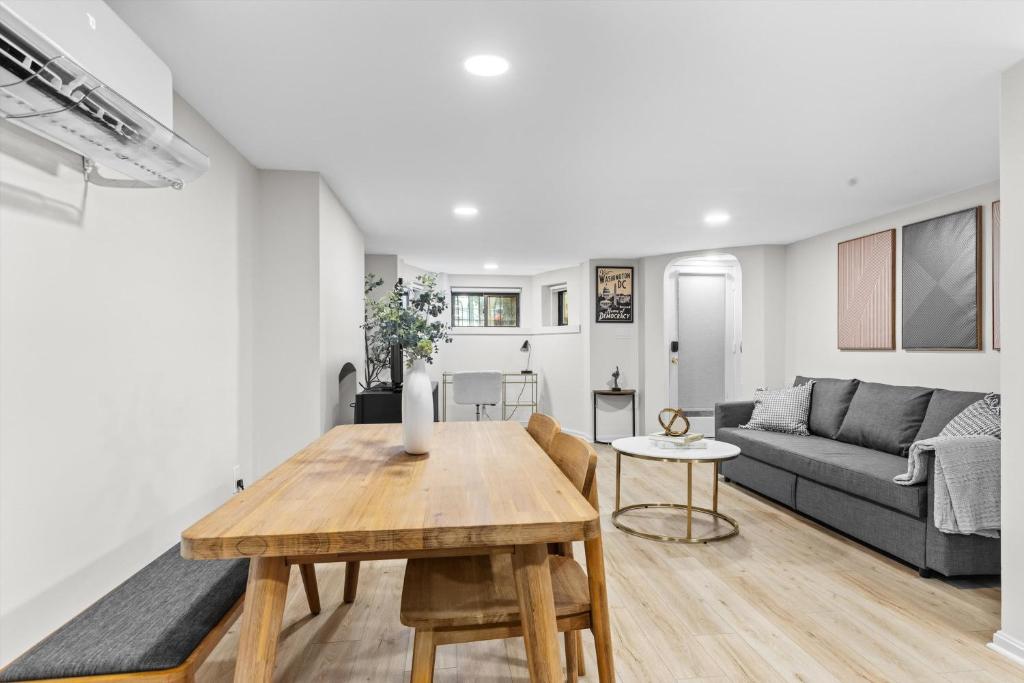 a living room with a table and a couch at Spacious NW Apt Steps to 14th Street Corridor in Washington, D.C.