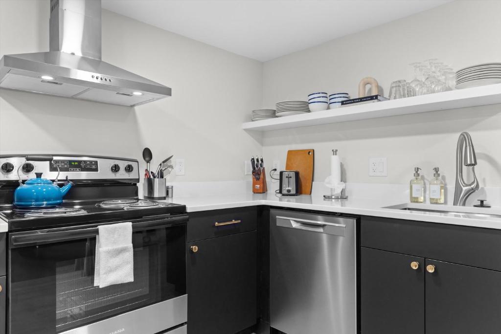 a kitchen with a stove and a sink at Spacious NW Apt Steps to 14th Street Corridor in Washington, D.C.