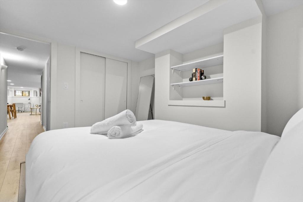 a white bed with a stuffed animal on top of it at Spacious NW Apt Steps to 14th Street Corridor in Washington, D.C.