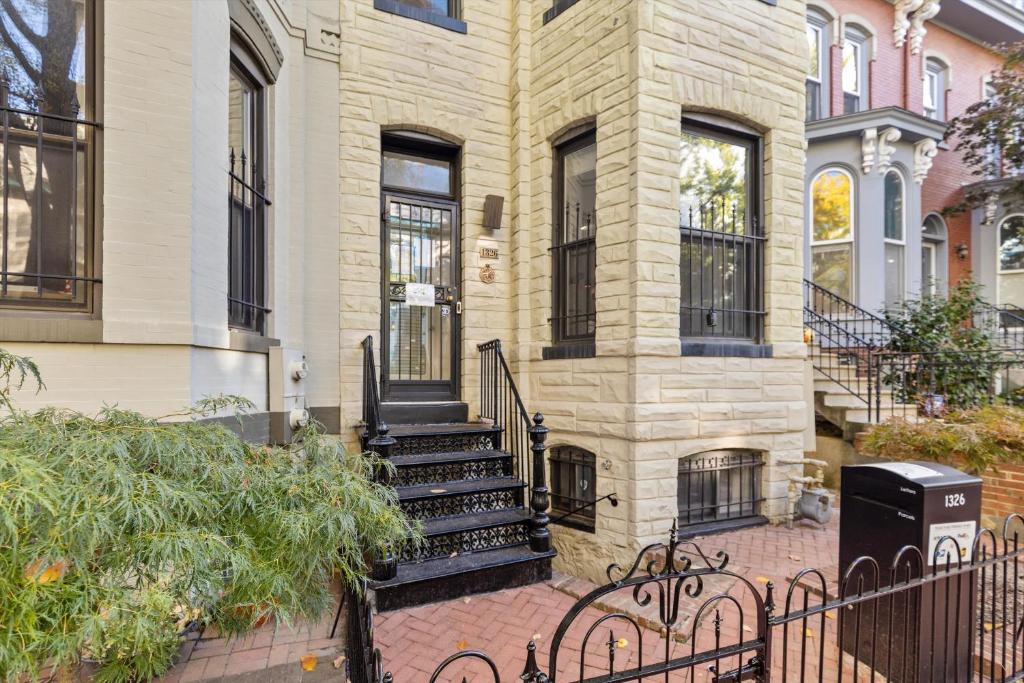 a building with a staircase in front of it at Spacious NW Apt Steps to 14th Street Corridor in Washington, D.C.