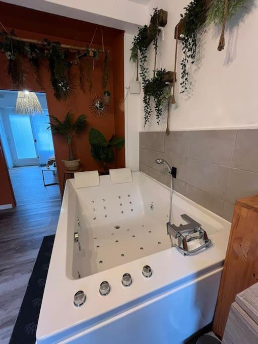 a kitchen with a white sink in a room at Appart cosy proche plage in Calais