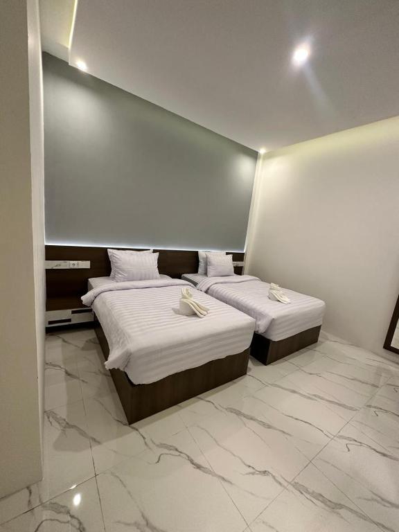 Postel nebo postele na pokoji v ubytování Resong Hotel