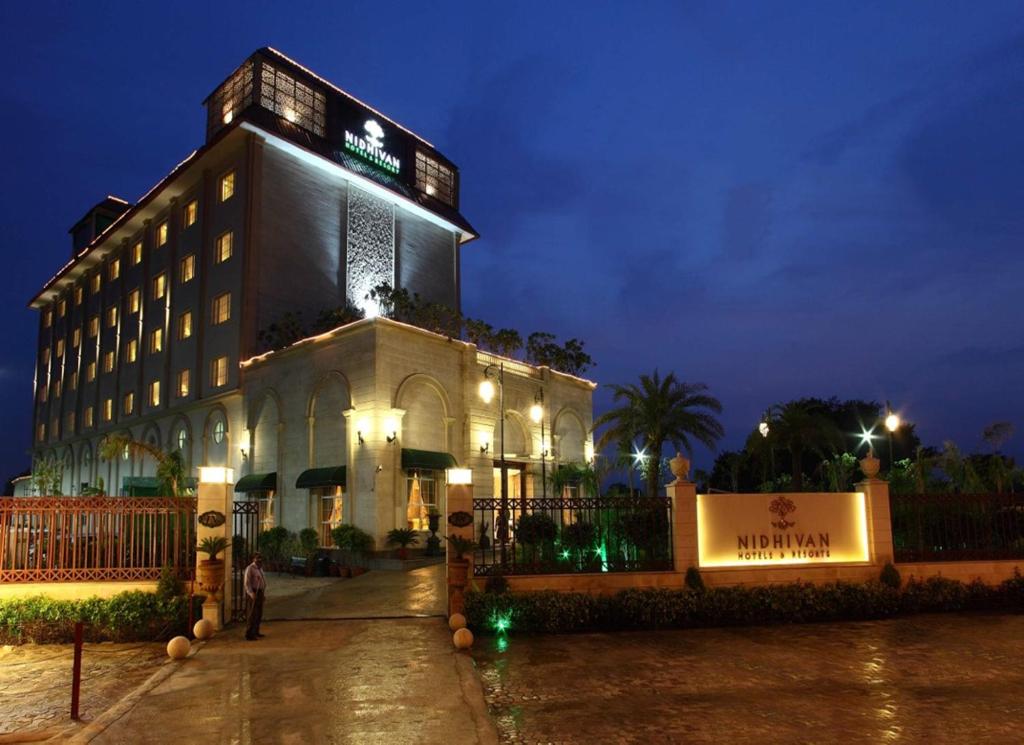 a building with a sign on top of it at night at Nidhivan Sarovar Portico Vrindavan in Vrindāvan