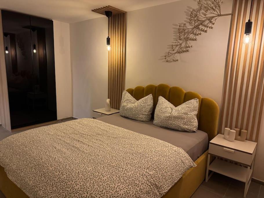a bedroom with a large bed with a yellow headboard at Traumhafte Nächte, unvergesslich in Chemnitz