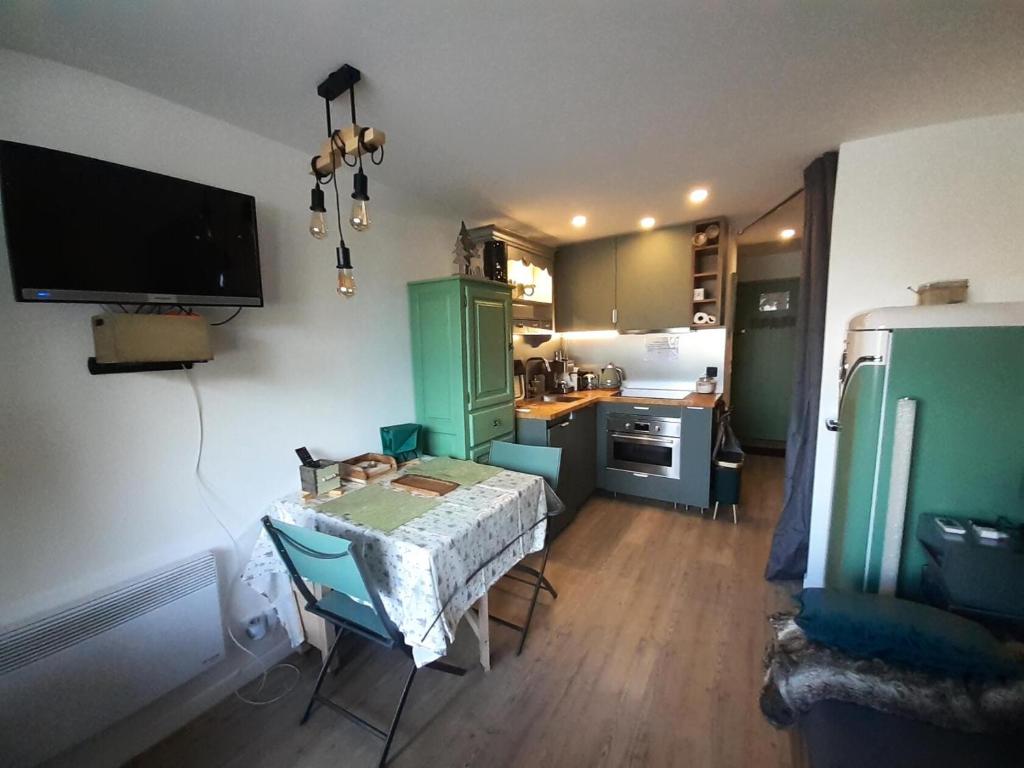 Il comprend une petite cuisine avec une table et un réfrigérateur. dans l'établissement Résidence Melezets 1 - Studio pour 3 Personnes MAE-2001, à Modane