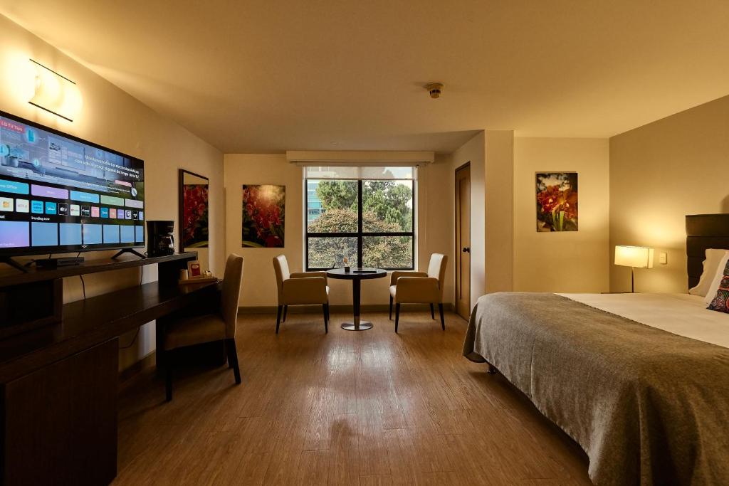 Postel nebo postele na pokoji v ubytování Hotel Parque 97 Suites
