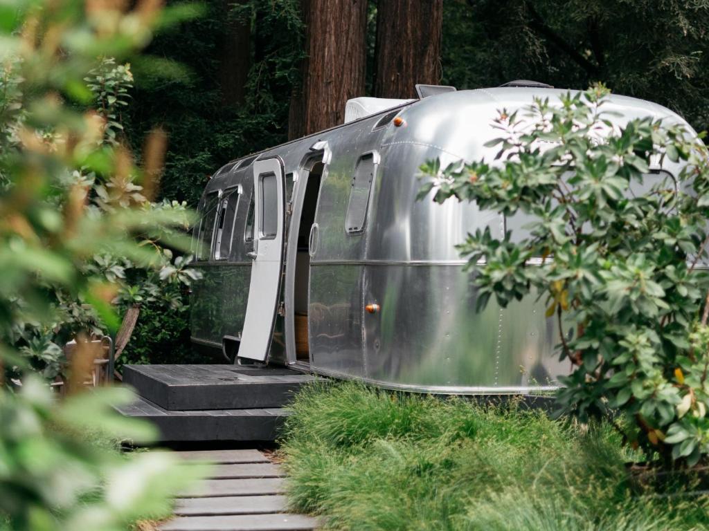 a silver trailer is sitting on the tracks at AutoCamp Sonoma in Guerneville