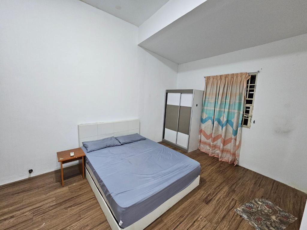 a small bedroom with a bed and a window at Amoy Lane Hostel Penang in George Town