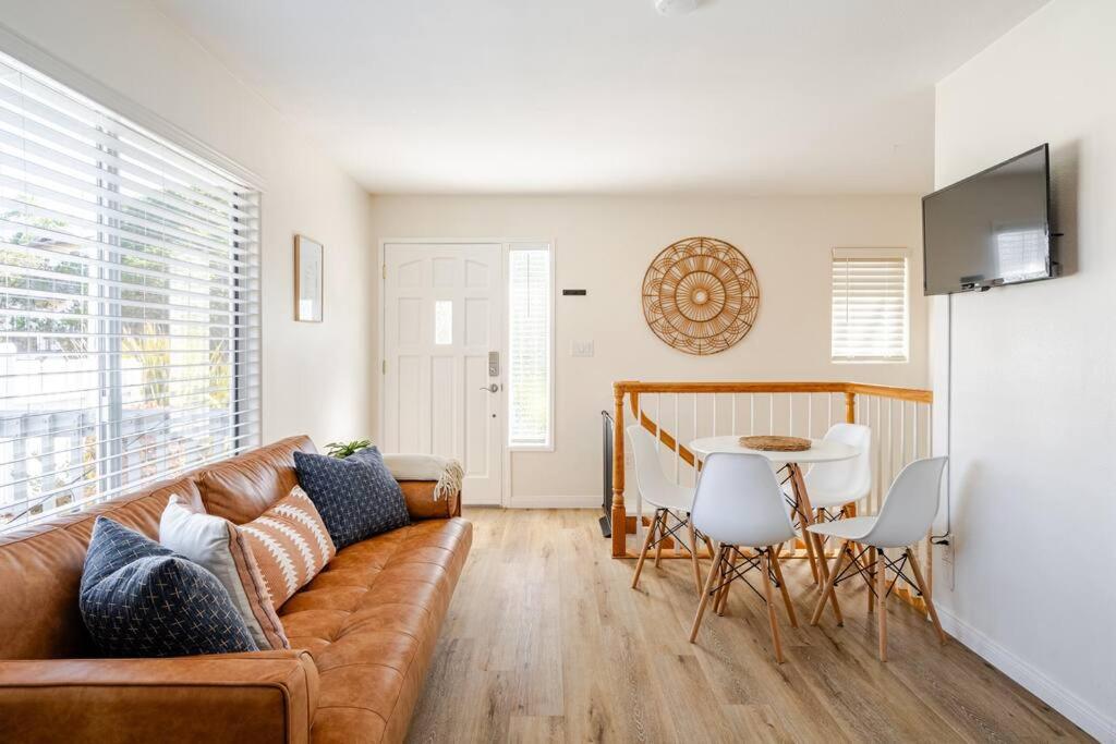 a living room with a couch and a table at Beacons Beach Cottage in Encinitas