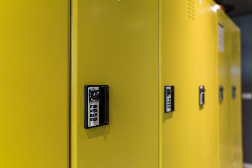 a yellow locker with remote controls on it at Taipei Discover Hostel in Taipei