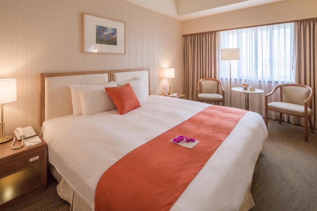 Postel nebo postele na pokoji v ubytování Hotel Riverview Taipei