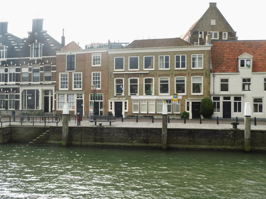 a group of buildings next to a body of water at All Exclusive Apartments in Dordrecht