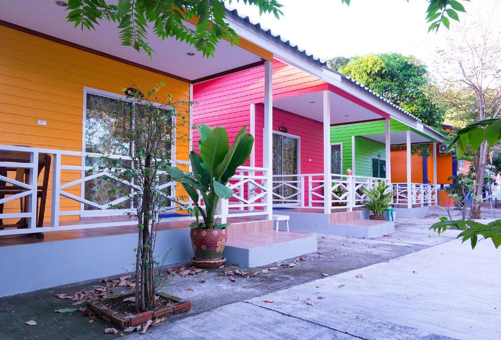 a colorful house with trees in front of it at Sichang Hut in Ko Si Chang