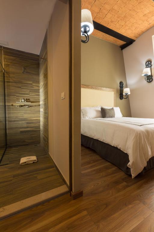 Postel nebo postele na pokoji v ubytování Historico Central Hotel